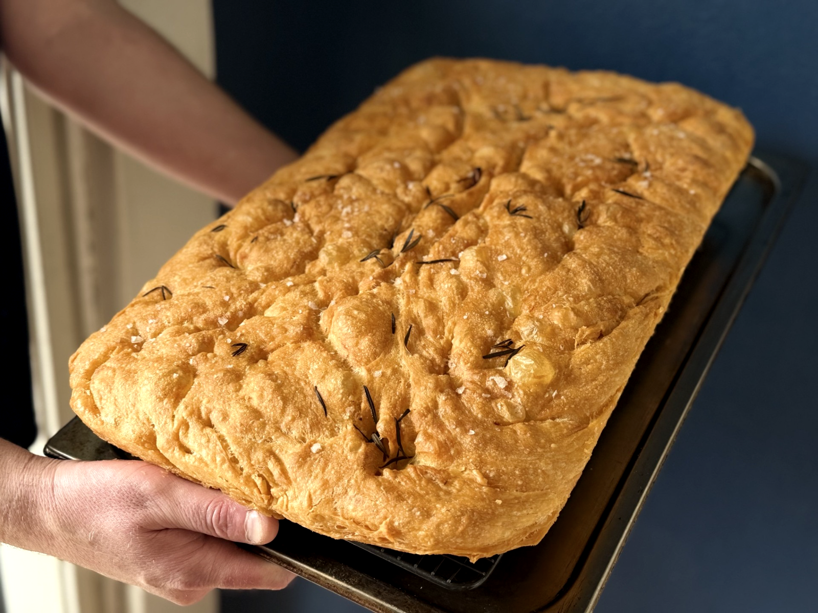 Freshly baked rosemary and sea salt focaccia on a tray