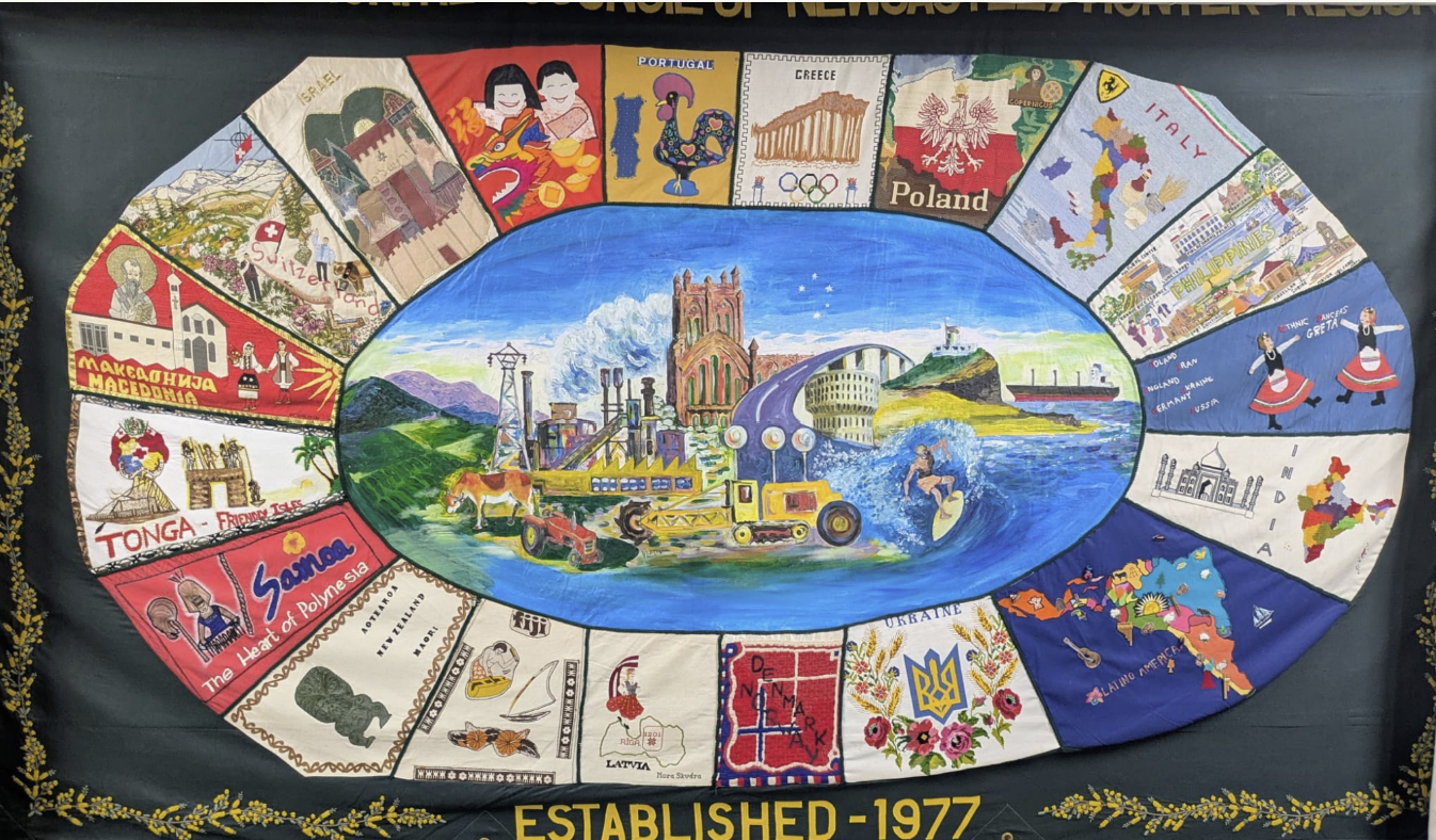 Hand-embroidered community banner celebrating HMC, established 1977