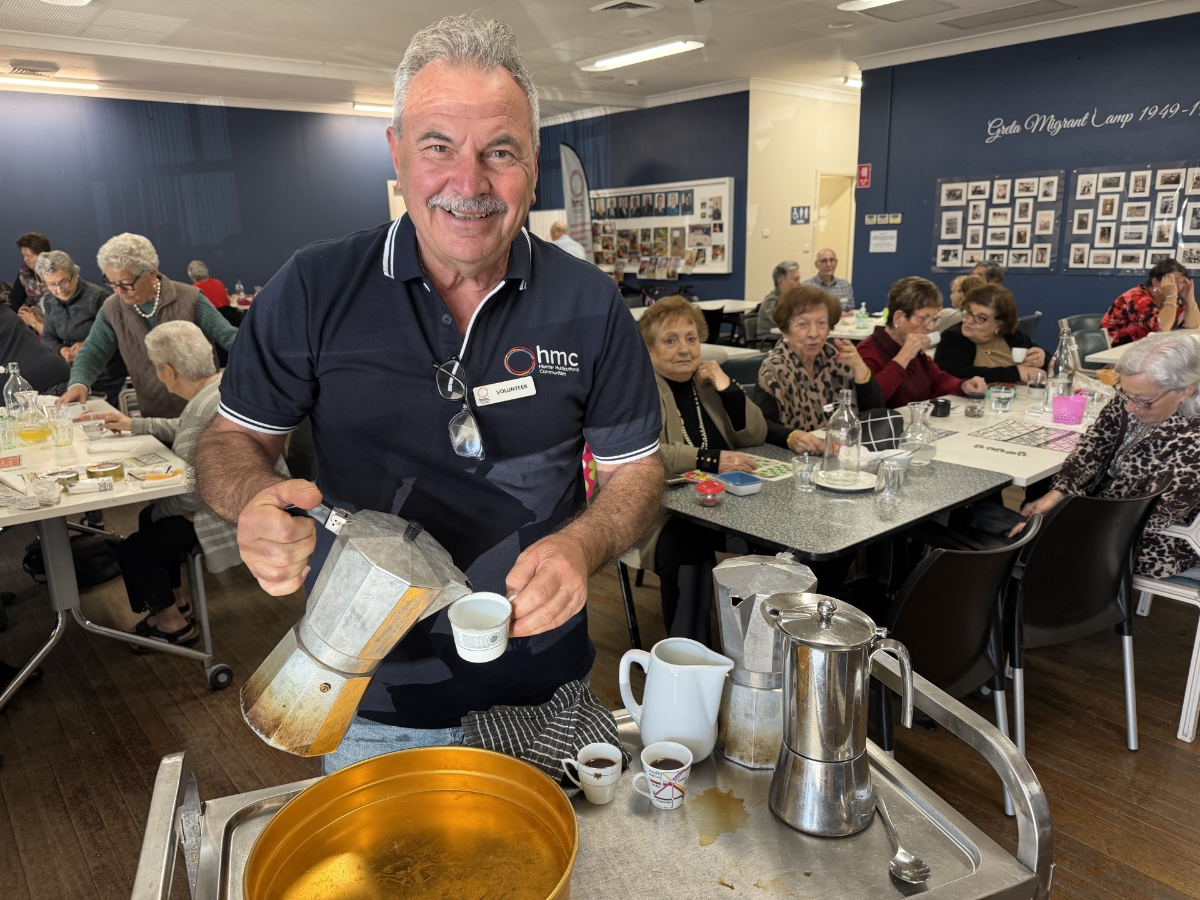 HMC volunteer serving coffee to seniors